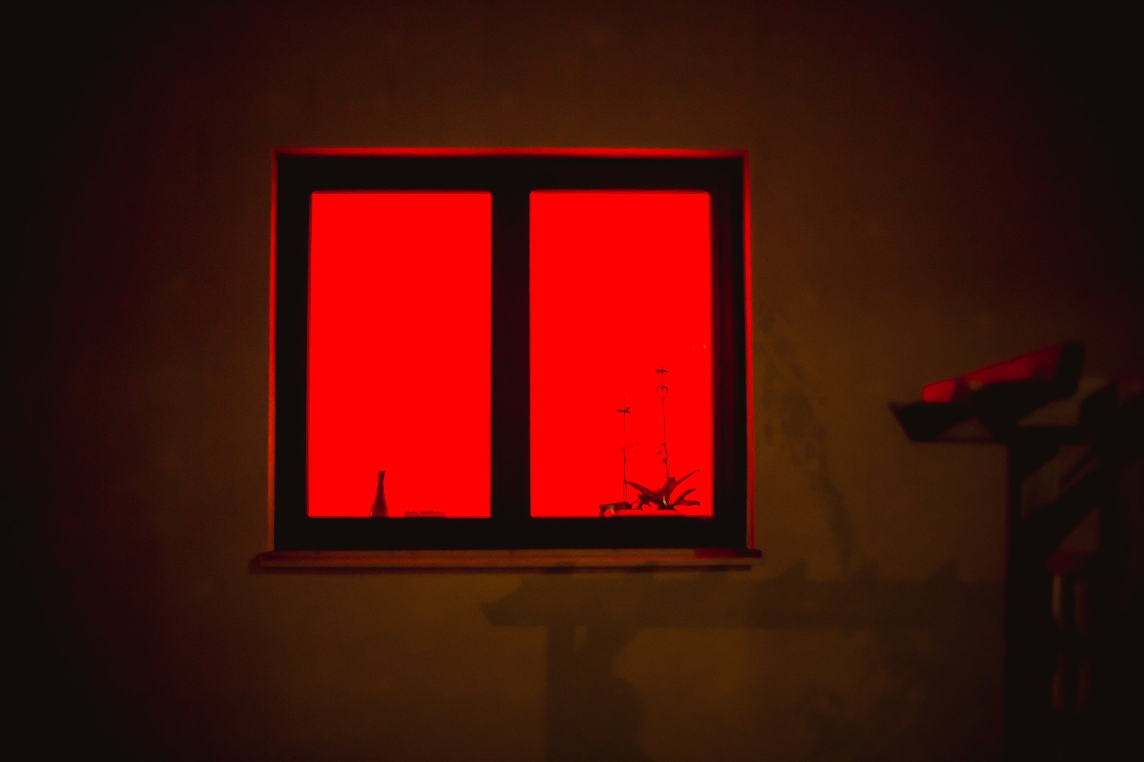 red light from the window. the red window shines mystically at night.